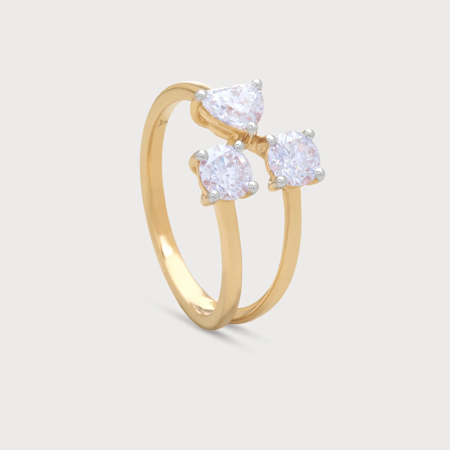 The Amara Ring: An elegant gold diamond ring featuring a prominent pear-shaped diamond and two sparkling round brilliant cut diamonds, ideal for a multi-stone or cluster diamond ring collection.