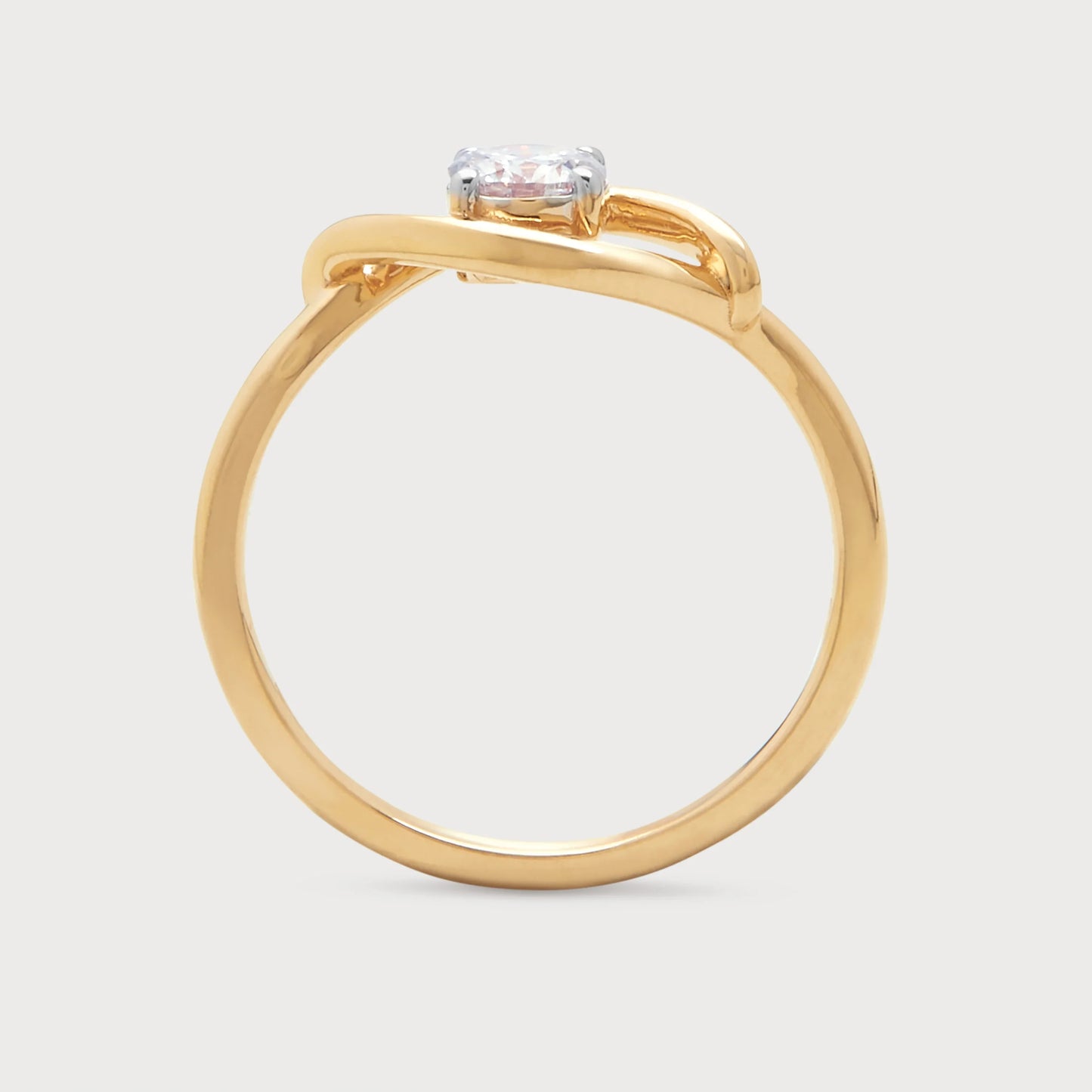 The Enso Ring: A yellow gold diamond ring featuring a brilliant solitaire diamond set in a unique, flowing, intertwined design. Ideal as an engagement ring or luxury diamond jewelry for women.