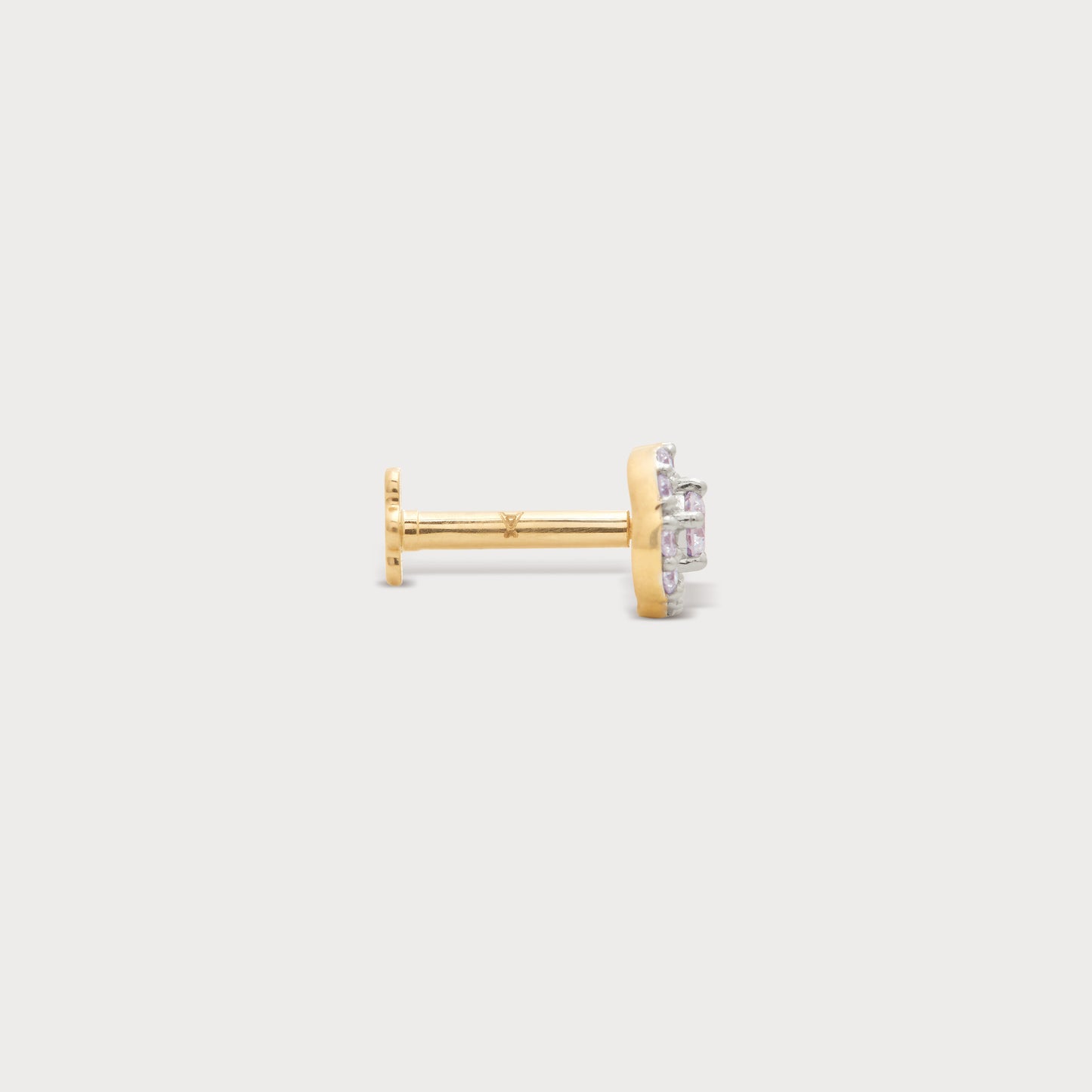 The Halo Spark Nose Pin, a luxurious yellow gold nose pin featuring sparkling pink diamonds in a halo setting. Exquisite diamond jewellery for nose piercings.