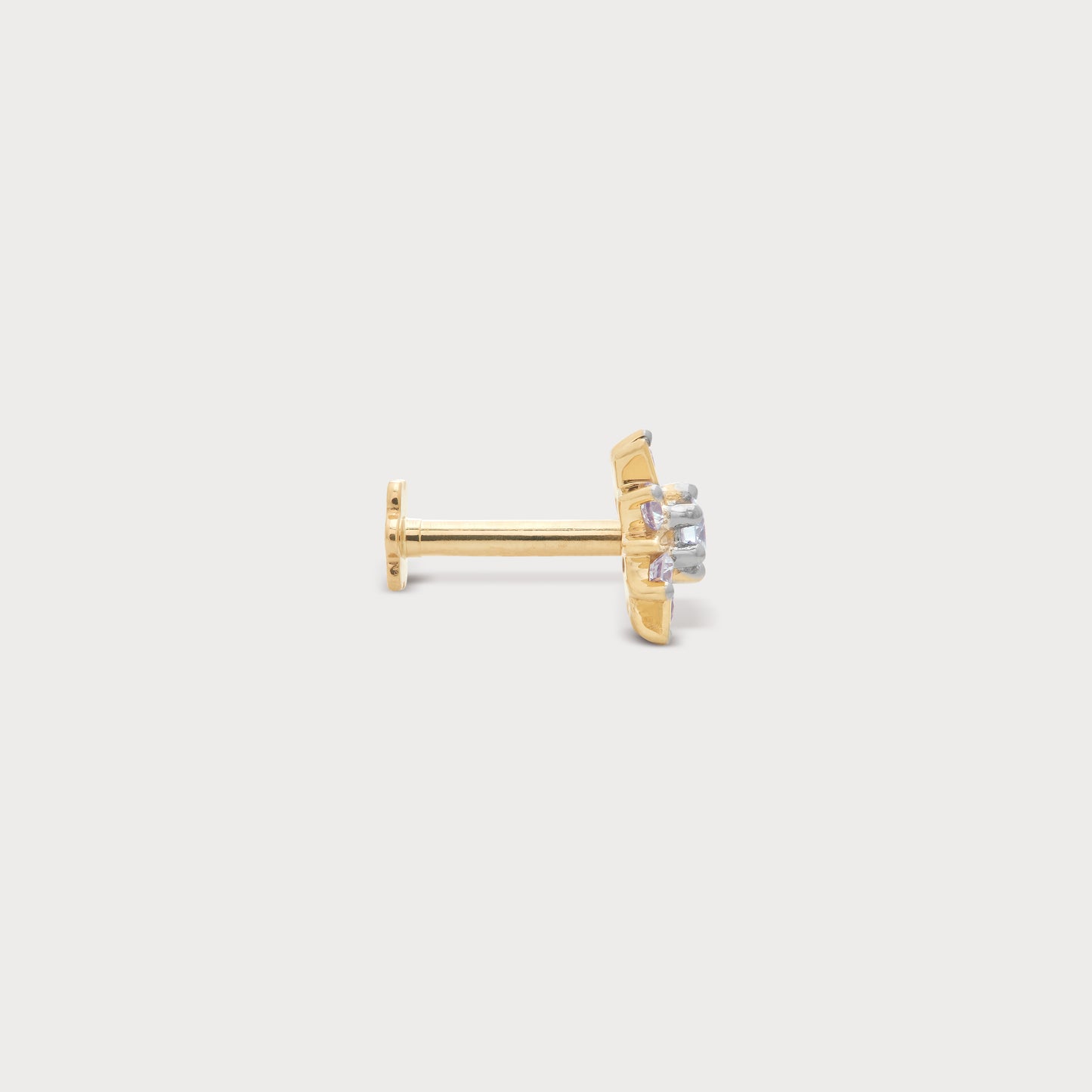 The Frostflake Nose Pin: Gold nose pin with sparkling diamonds set in a delicate frostflake design, a piece of fine diamond jewellery.