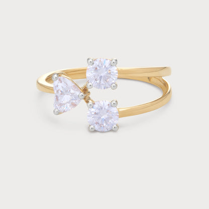The Amara Ring - A modern bypass yellow gold ring featuring three sparkling diamonds: two round brilliant cut and one pear-shaped, perfect for engagements or a statement piece of diamond jewelry.