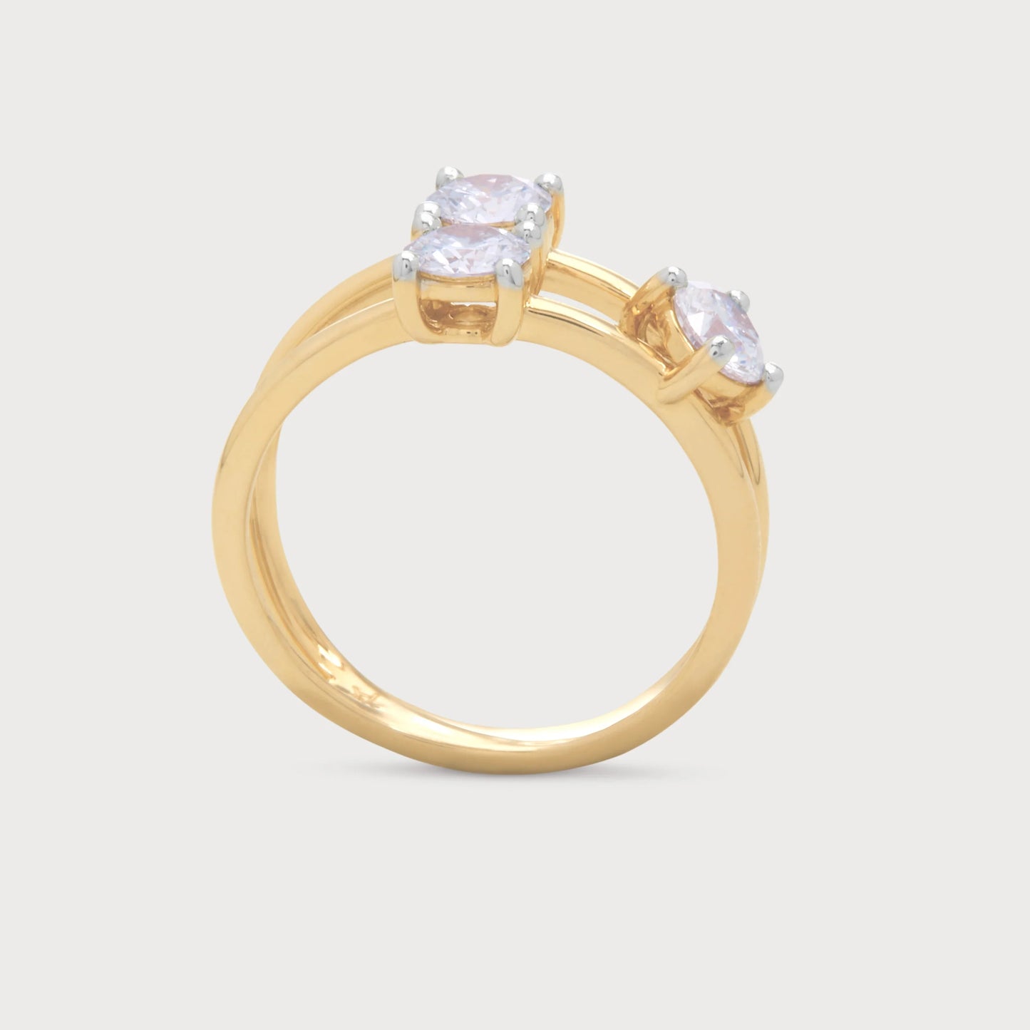 The Calista Ring - elegant gold diamond ring with three brilliant diamonds on an intertwined band. Shop unique diamond jewelry.