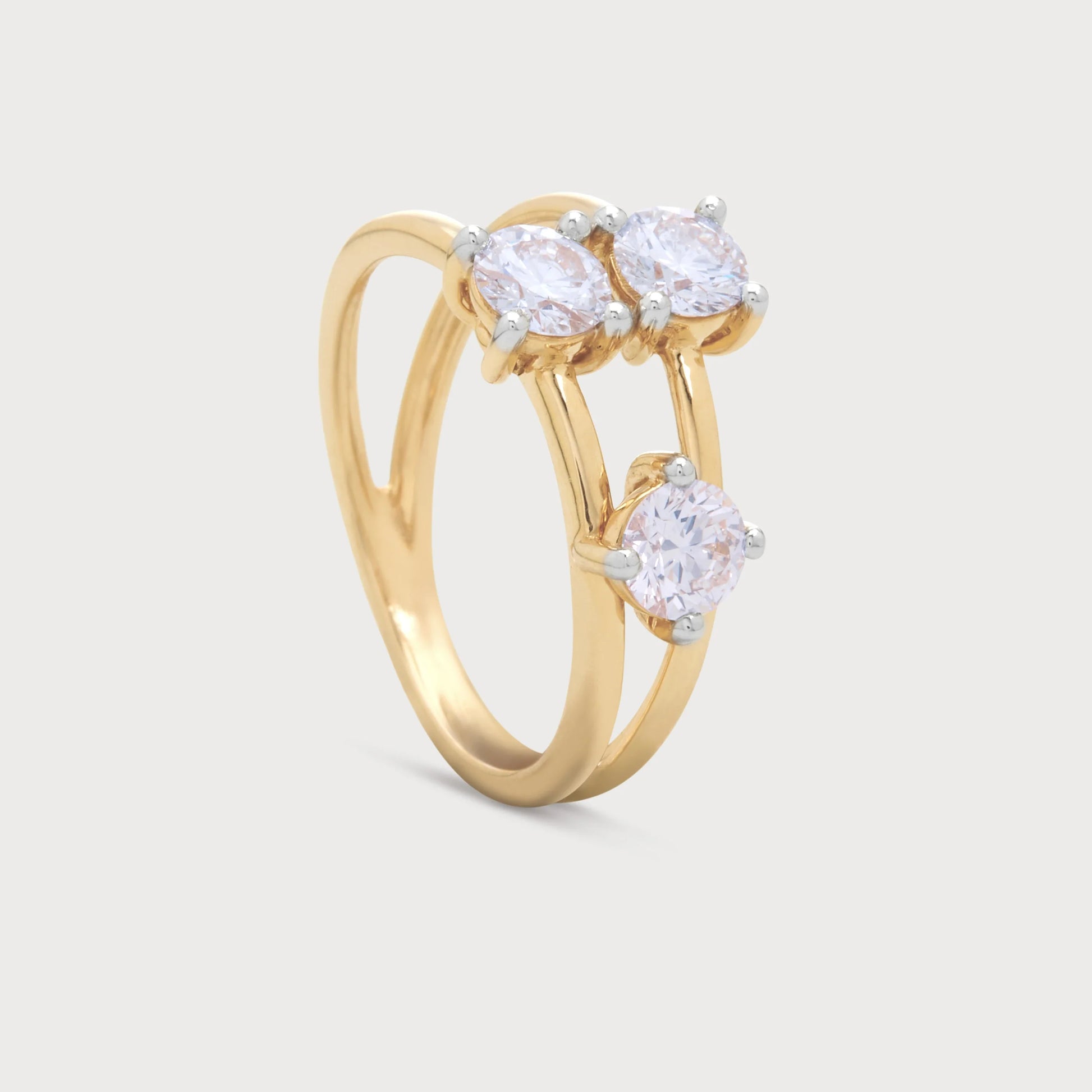 The Calista Ring, an exquisite yellow gold diamond ring featuring three brilliant round diamonds in a unique two-tier setting, perfect for engagement or a luxurious gift.