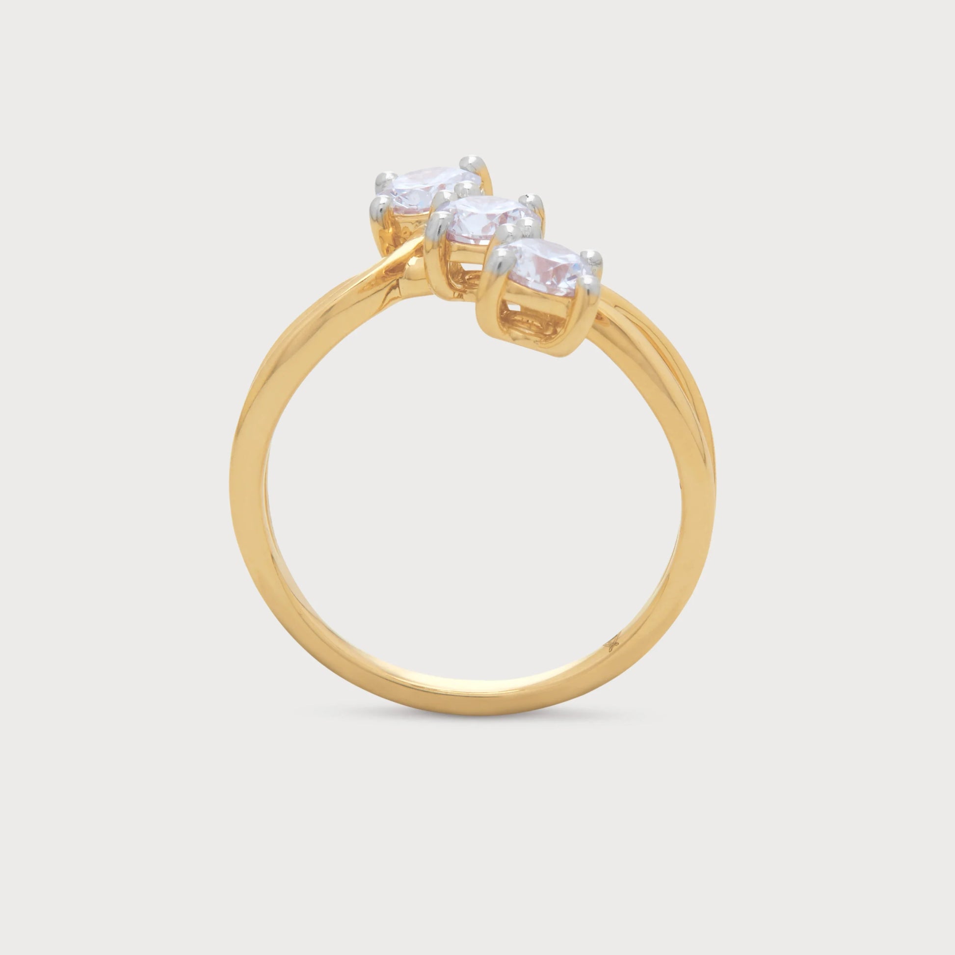 The Trinity Twist Ring, a beautiful yellow gold three-stone diamond ring featuring a gracefully twisted band. Perfect diamond jewelry for engagement, anniversary, or special occasions.
