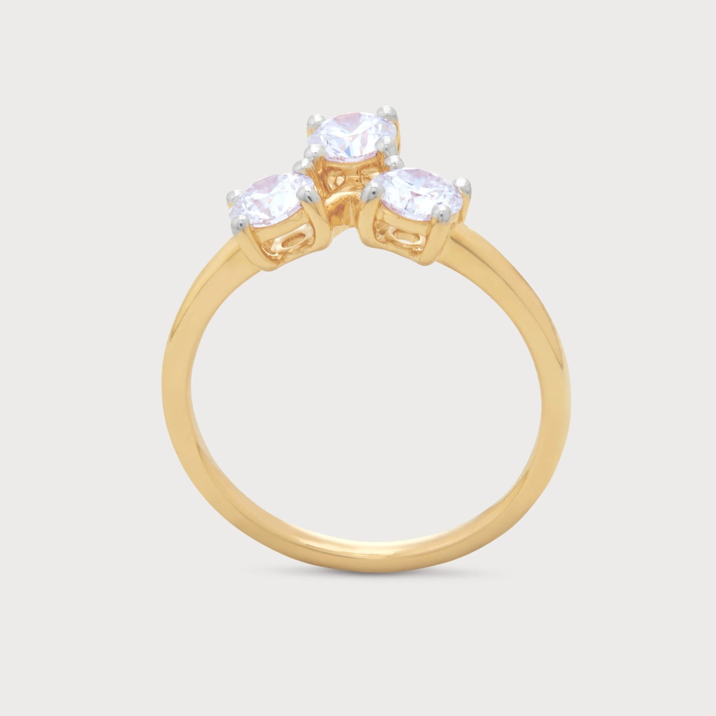 The Solis Ring: Yellow gold three-stone diamond ring with sparkling round brilliant cut diamonds.