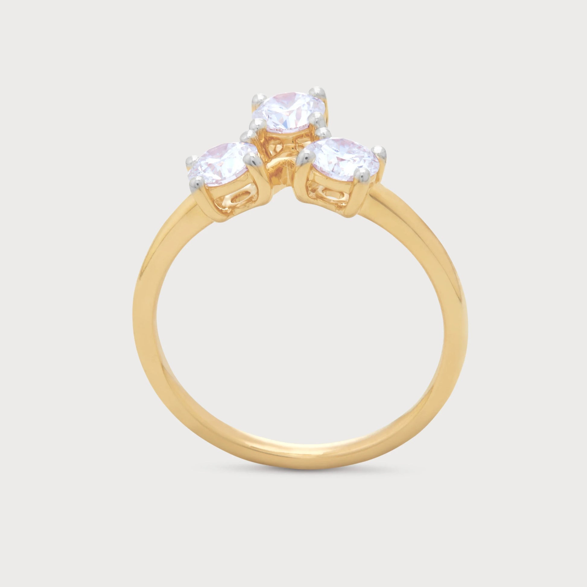 The Solis Ring: Yellow gold three-stone diamond ring with sparkling round brilliant cut diamonds.