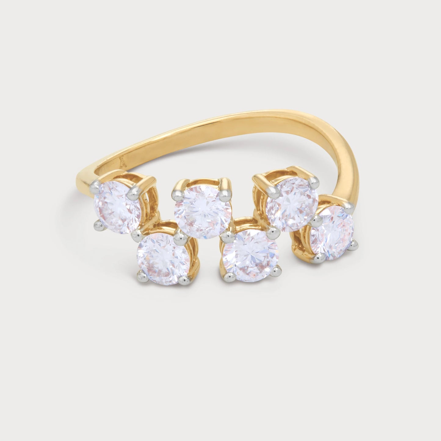 The Svara Ring: Yellow gold multi-stone diamond wrap-around ring featuring six round brilliant diamonds with white gold prongs. Fine diamond jewelry for women.