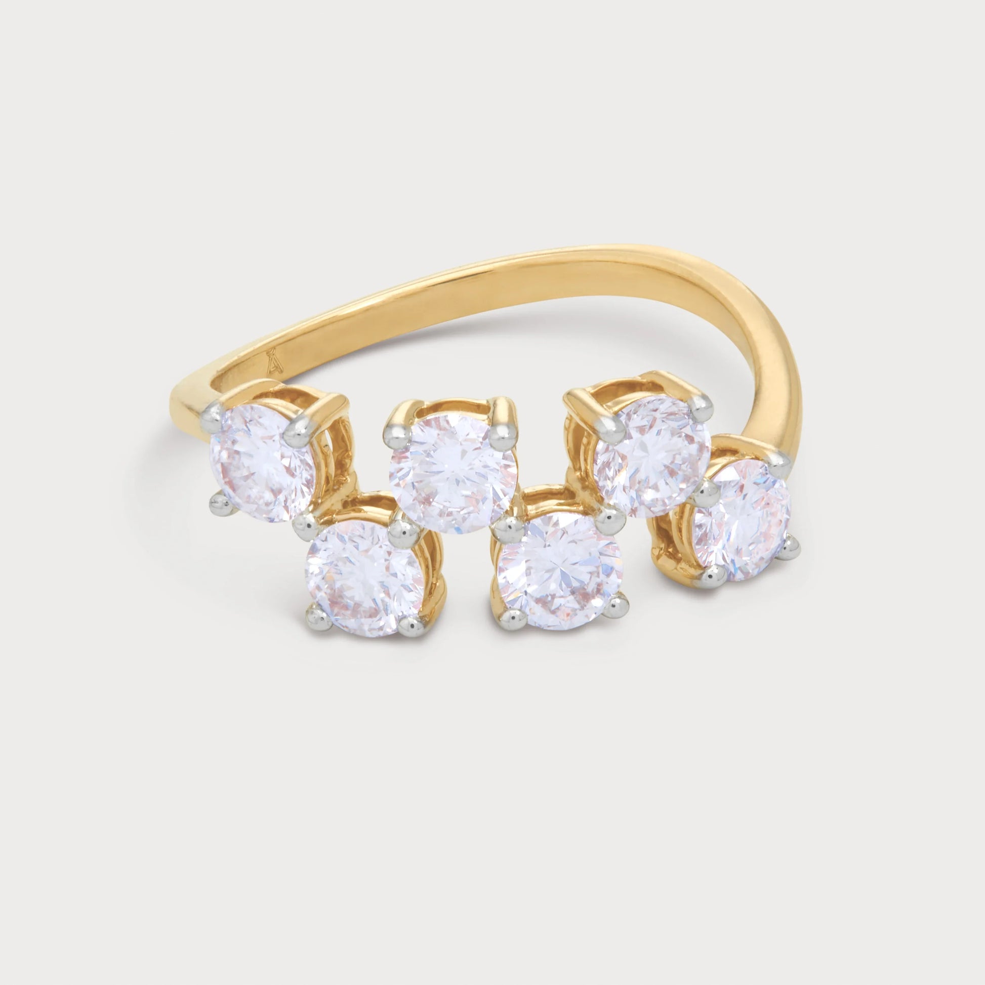 The Svara Ring: Yellow gold multi-stone diamond wrap-around ring featuring six round brilliant diamonds with white gold prongs. Fine diamond jewelry for women.