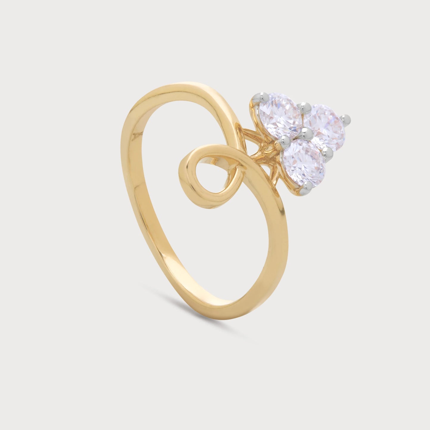 The Triveni Ring, a yellow gold ring featuring a cluster of three brilliant round diamonds and a unique swirl band design, ideal for diamond jewelry ecommerce.