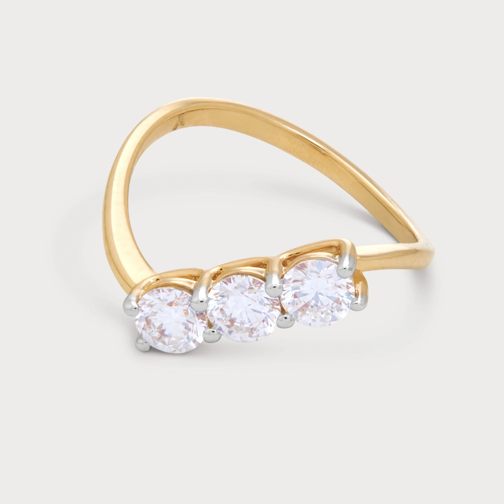 The Samara Ring - elegant three-stone diamond ring with a curved gold band, perfect for engagement, wedding, or anniversary. High-quality fine jewelry.