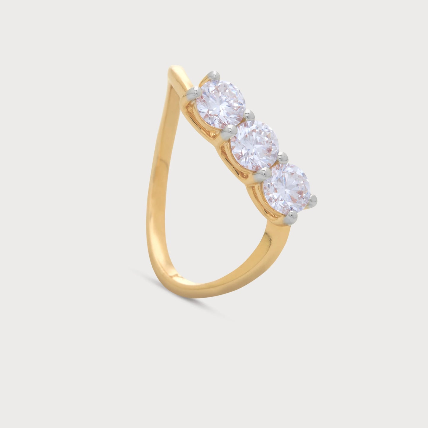 The Samara Ring: Elegant yellow gold diamond ring featuring three round brilliant cut diamonds set diagonally, perfect for modern women's fine jewelry.
