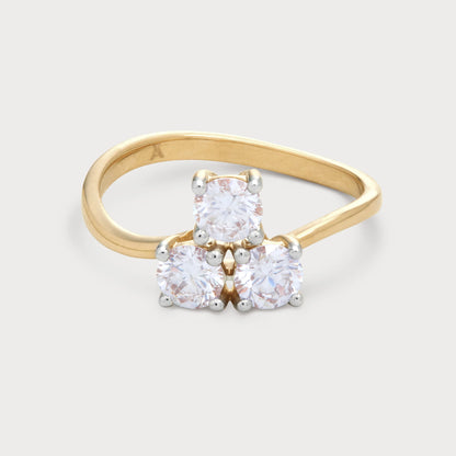 The Arvia Bloom Ring: a yellow gold three-stone diamond ring featuring three brilliant round diamonds set in a floral cluster design. Ideal for engagement or a special gift.