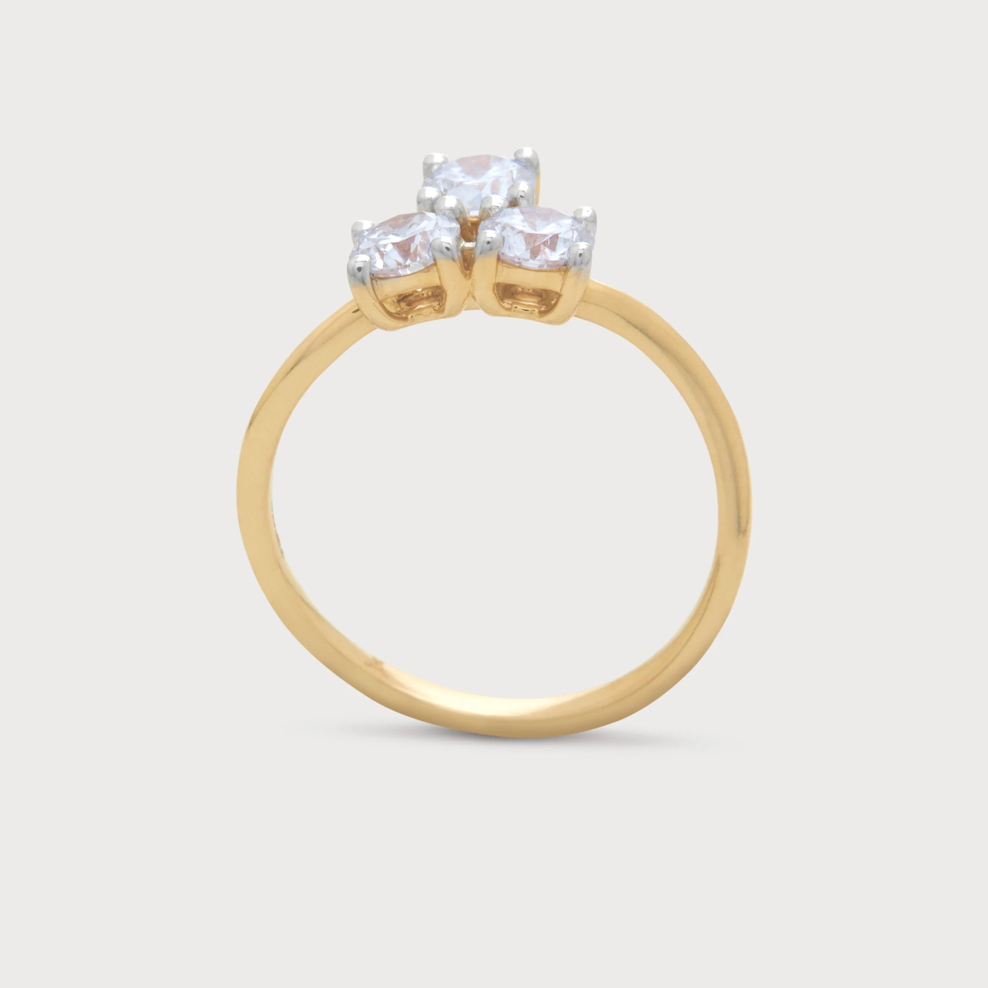 The Arvia Bloom Ring, a gold diamond ring featuring three sparkling round brilliant diamonds, ideal for engagement, wedding, or anniversary occasions.