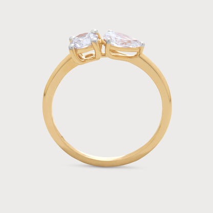 The Fleur Sol Ring: A yellow gold two-stone diamond ring featuring a round-cut and a pear-cut diamond. Fine diamond jewelry for women.