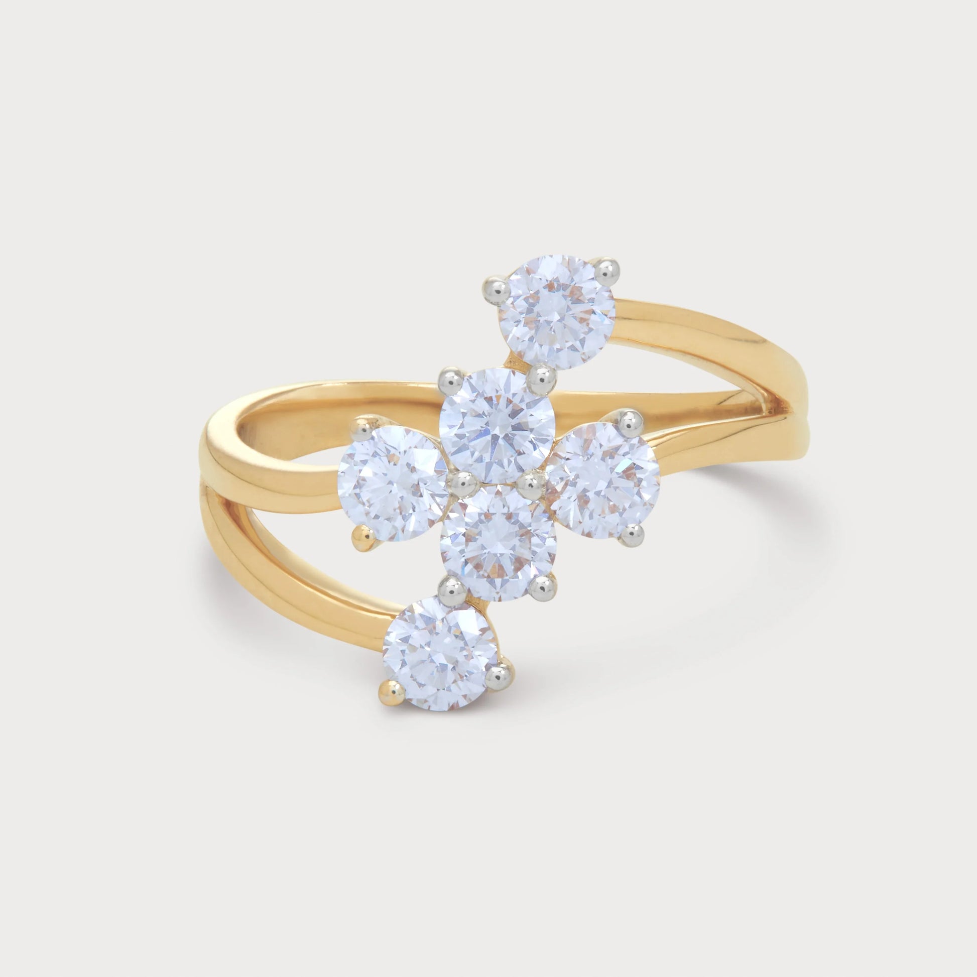 The Asteris Ring, a stunning yellow gold bypass ring featuring a brilliant cluster of round diamonds, perfect for women's fine diamond jewelry.