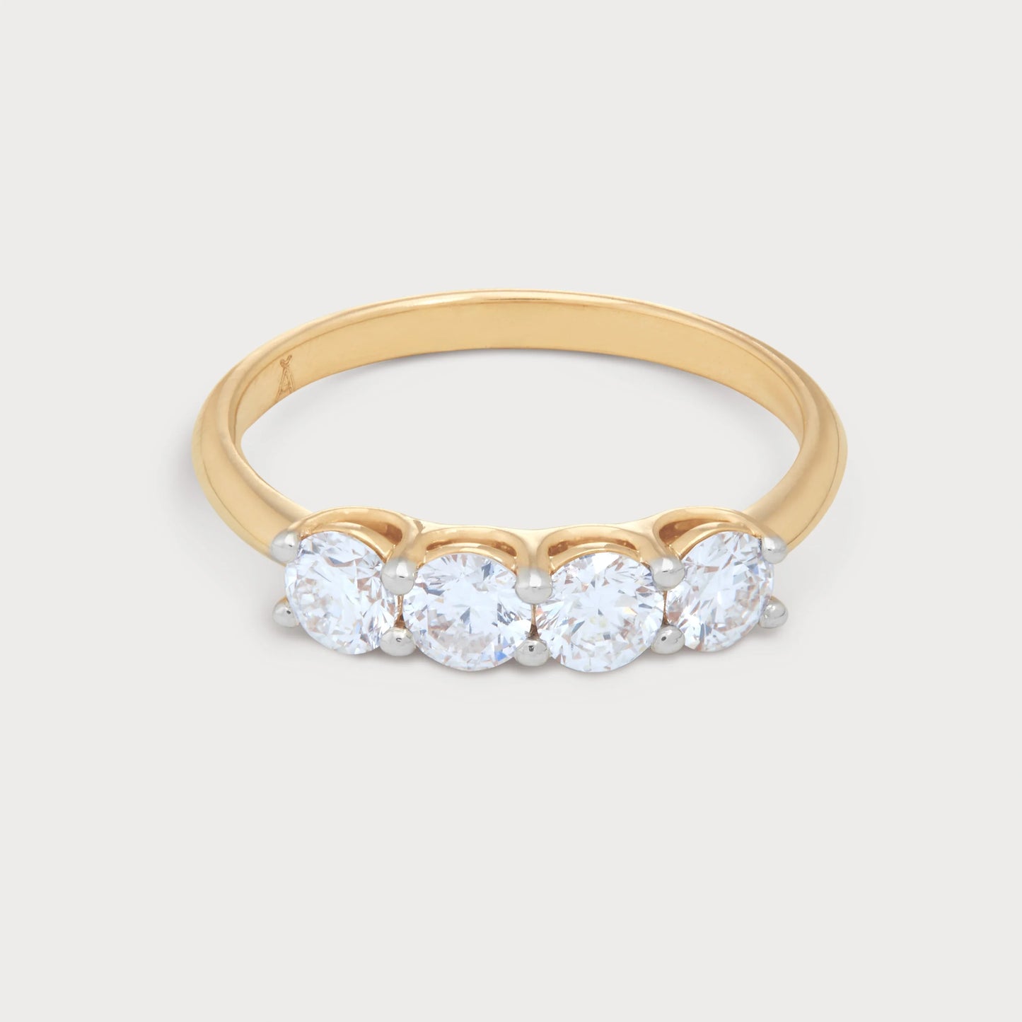 The Zaya Ring: A stunning four-stone diamond ring with a polished gold band, perfect for engagement, anniversary, or fine jewelry collection.