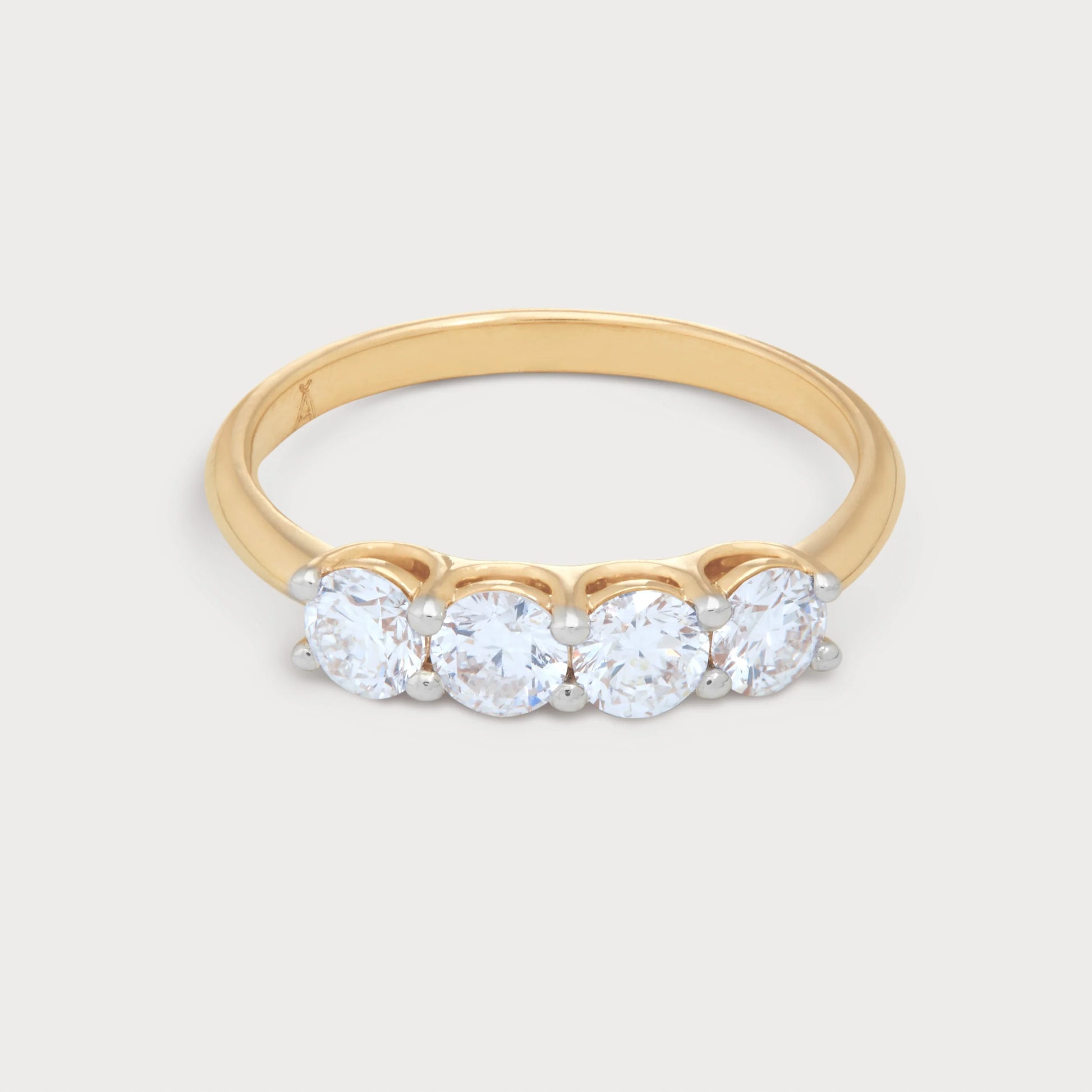 The Zaya Ring: A stunning four-stone diamond ring with a polished gold band, perfect for engagement, anniversary, or fine jewelry collection.