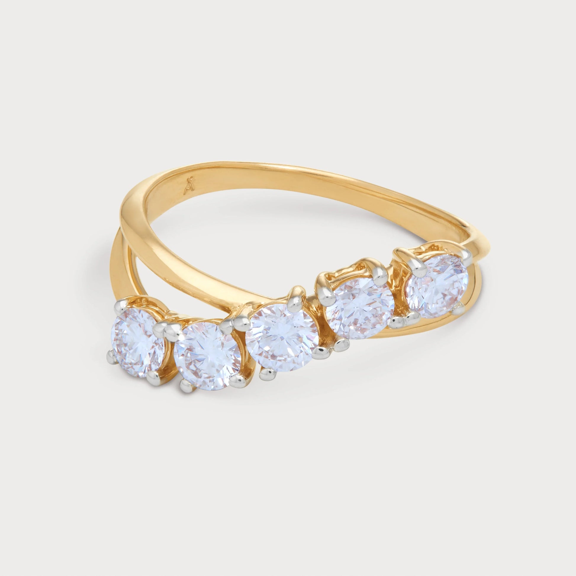 The Alouette Ring: A stunning five-stone curved diamond ring in yellow gold, perfect for an engagement, anniversary, or fashion statement. Features five brilliant round cut diamonds set in a modern wave design. Shop luxurious diamond jewelry and rings.