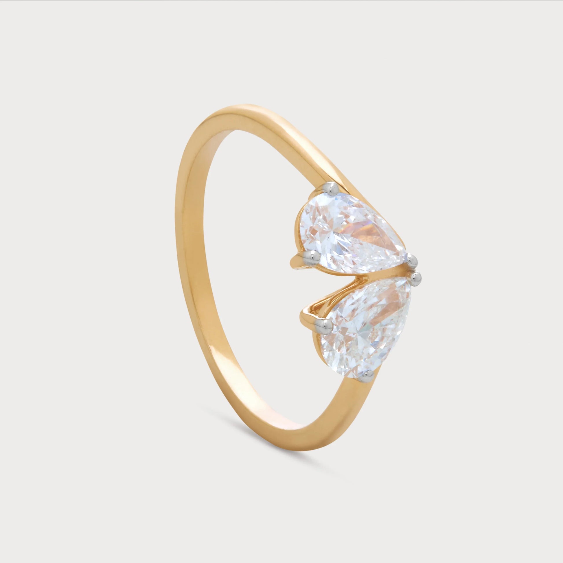 The Zephra Ring: Gold diamond ring with two pear-shaped diamonds. Shop fine diamond jewelry online.