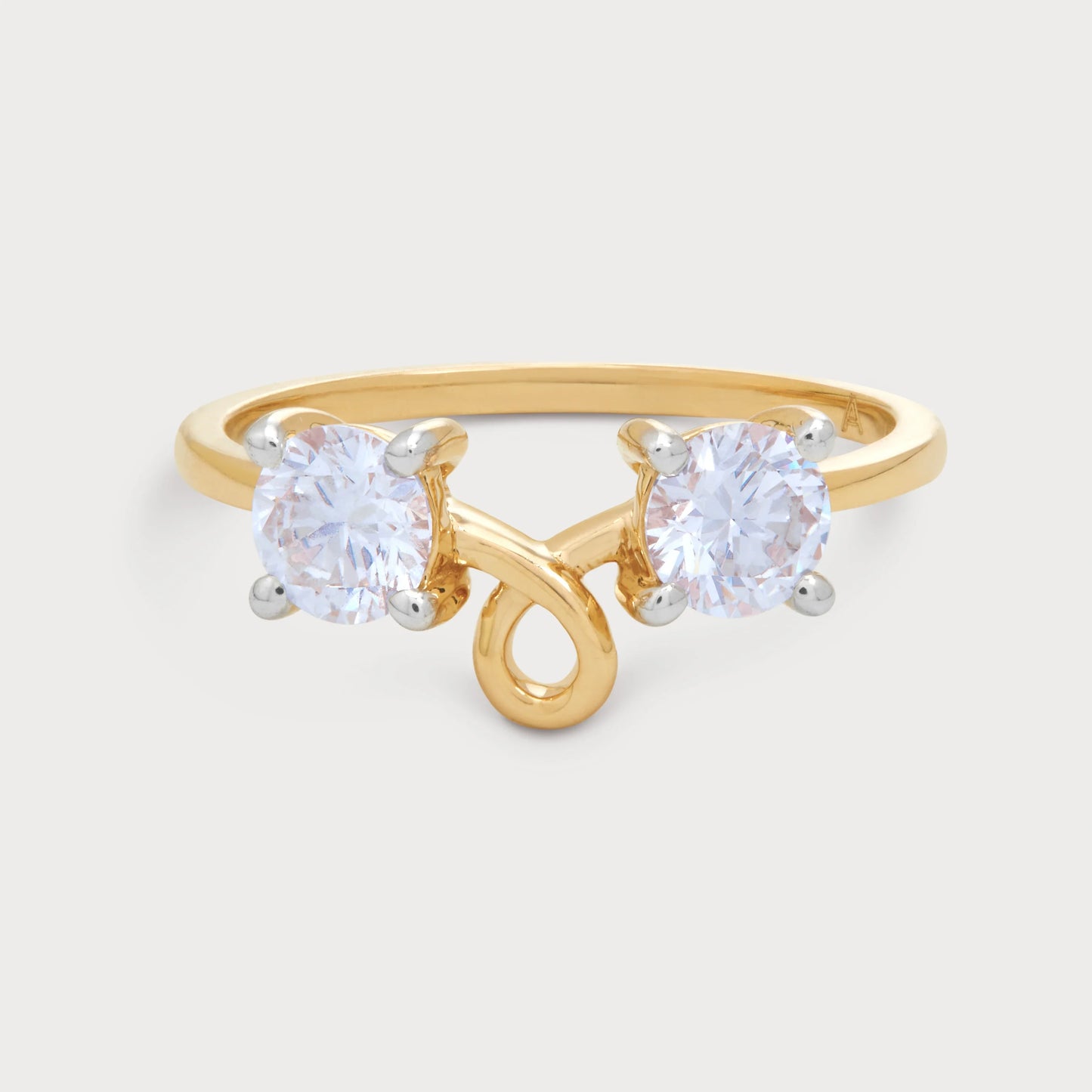 Elegant Caia Ring featuring two sparkling round diamonds set in a distinctive yellow gold bypass band, perfect for a modern jewelry collection.