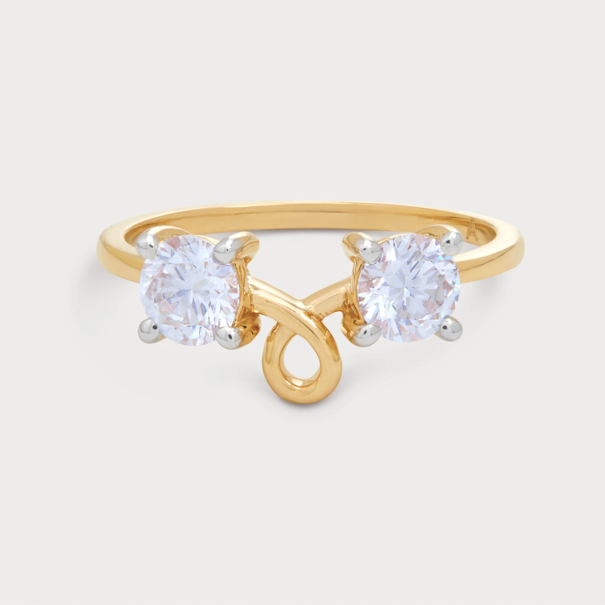Elegant Caia Ring featuring two sparkling round diamonds set in a distinctive yellow gold bypass band, perfect for a modern jewelry collection.