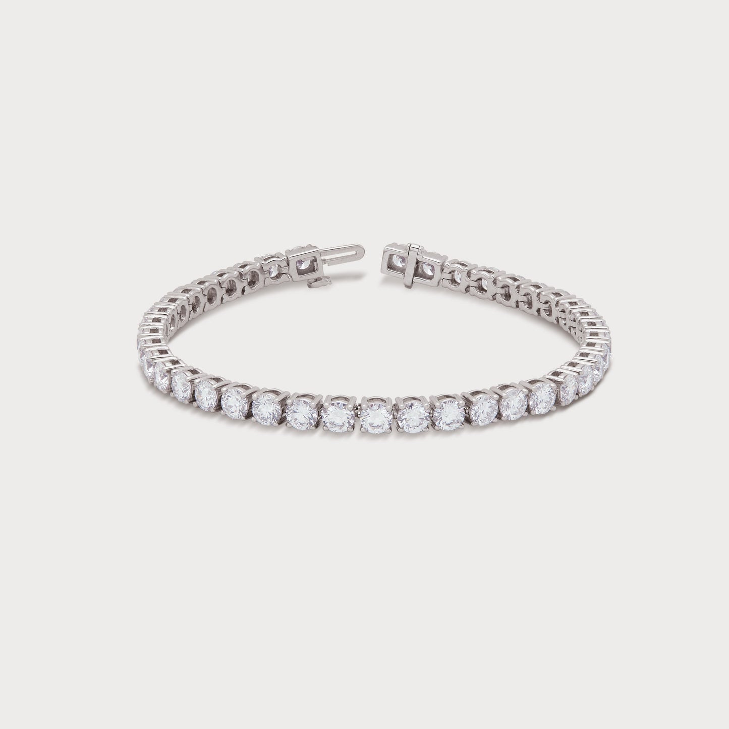 The Grand Tennis Bracelet featuring brilliant-cut diamonds set in a white gold or platinum band, perfect for a luxurious diamond jewelry gift or elegant accessory.
