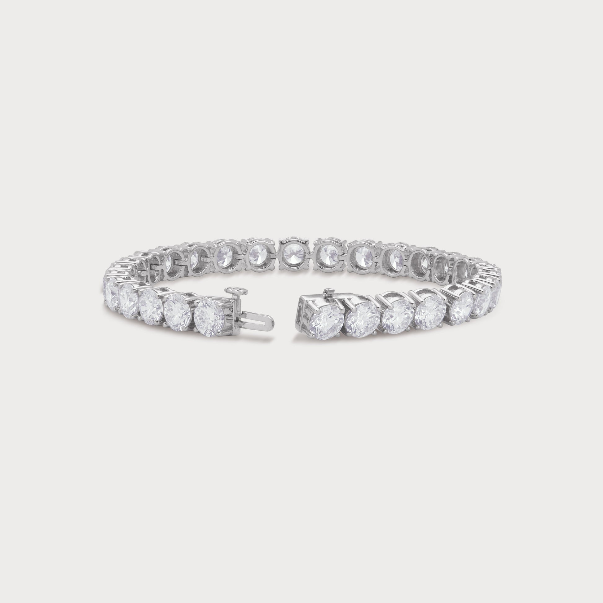 The Regal Tennis Bracelet featuring a continuous line of sparkling round brilliant cut diamonds set in white gold. A luxurious fine diamond jewelry piece for women.