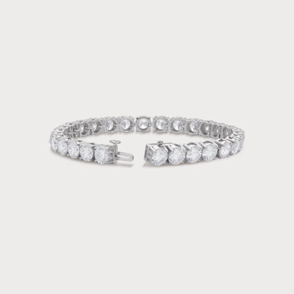 The Regal Tennis Bracelet featuring a continuous line of sparkling round brilliant cut diamonds set in white gold. A luxurious fine diamond jewelry piece for women.