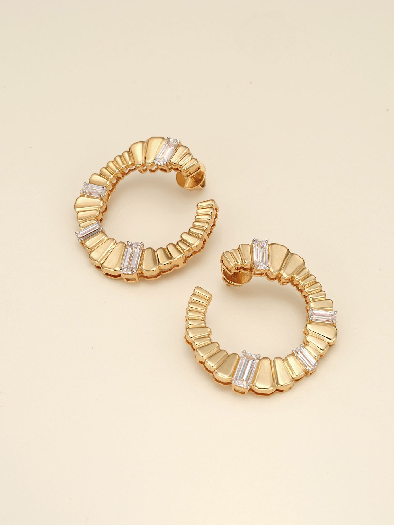 The Echoes of Choice Earrings: Gold hoop earrings with baguette diamonds, diamond jewellery.