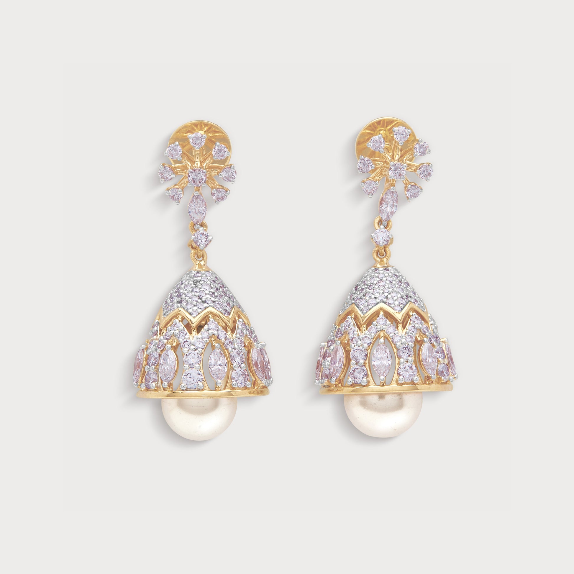 The Flora Diamond Jhumkas, exquisite gold-toned jhumka earrings featuring sparkling clear and pink diamonds with elegant pearl drops, perfect for traditional Indian jewellery lovers.