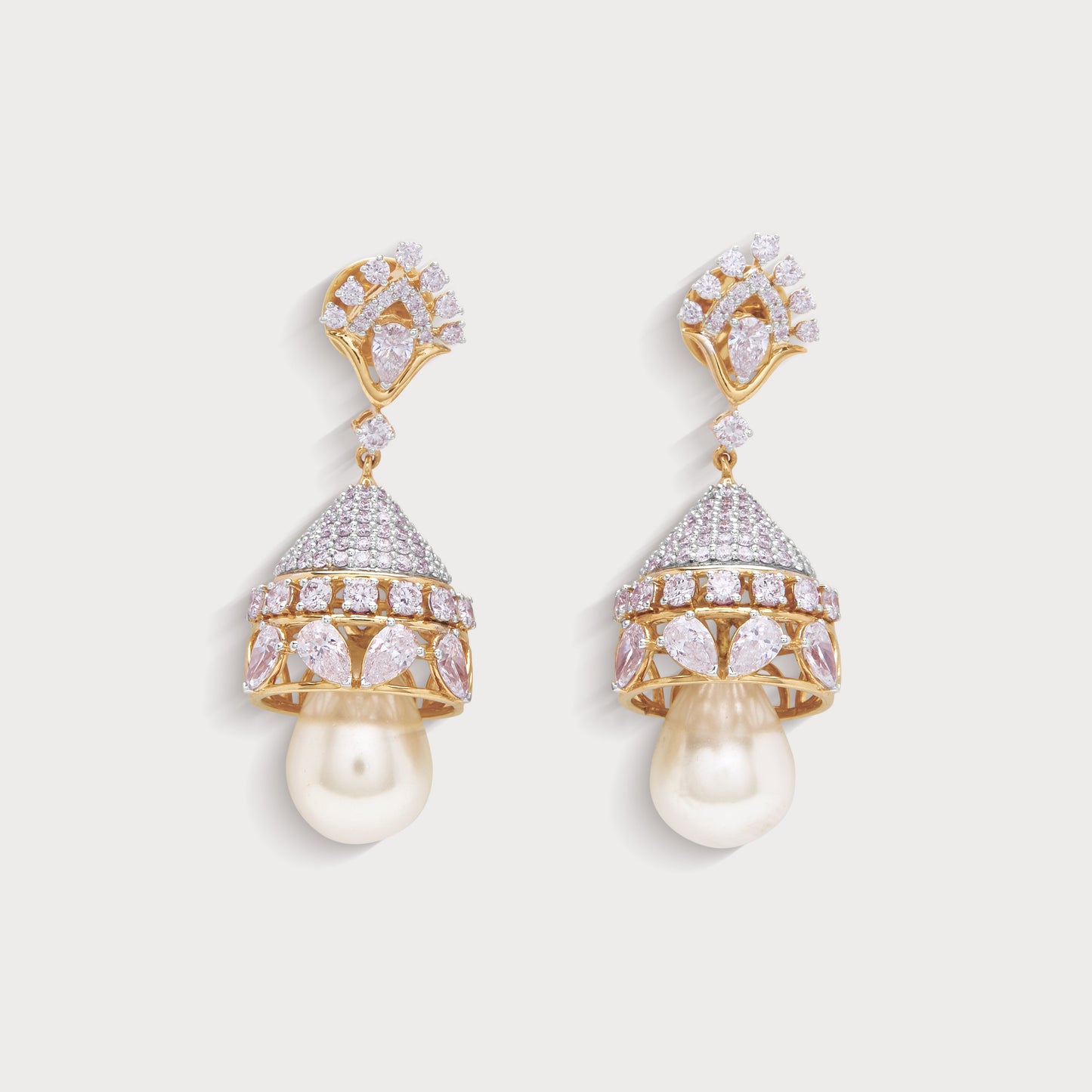 Chandini Jhumkas, exquisite diamond and pink gemstone jhumka earrings with pearl drops in a gold setting. Perfect for an ecommerce diamond jewelry store, these luxurious bell-shaped earrings enhance traditional and contemporary looks.