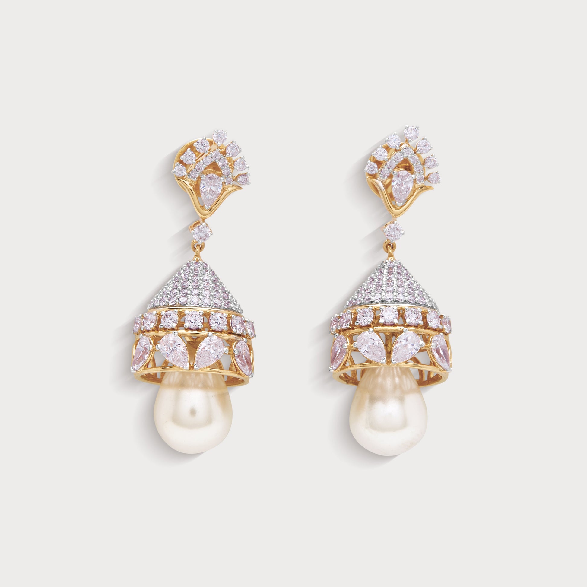 Chandini Jhumkas, exquisite diamond and pink gemstone jhumka earrings with pearl drops in a gold setting. Perfect for an ecommerce diamond jewelry store, these luxurious bell-shaped earrings enhance traditional and contemporary looks.