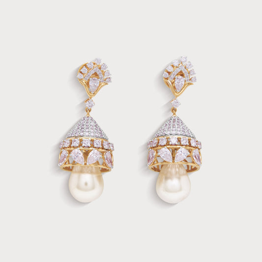 Chandini Jhumkas, exquisite diamond and pink gemstone jhumka earrings with pearl drops in a gold setting. Perfect for an ecommerce diamond jewelry store, these luxurious bell-shaped earrings enhance traditional and contemporary looks.