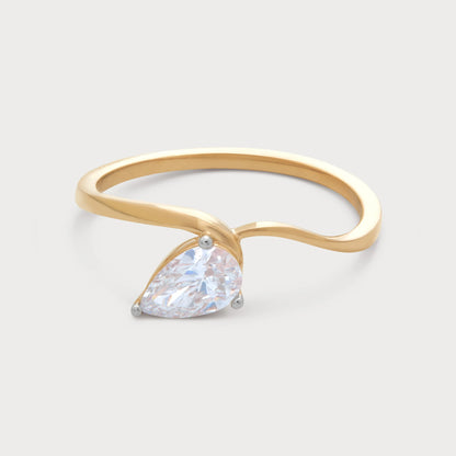 The Serelis Ring: elegant gold diamond ring with a dazzling pear-shaped diamond in a unique, modern setting. Perfect for engagement or a sophisticated jewelry gift. Shop fine diamond jewelry.