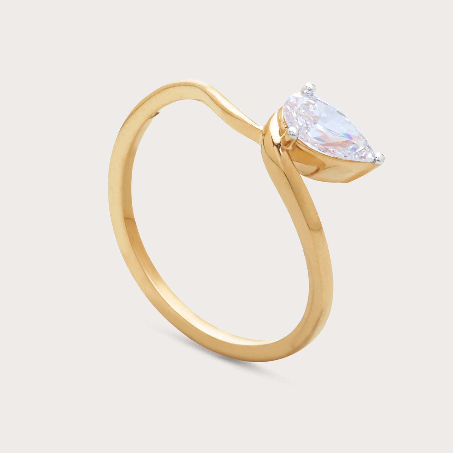 The Serelis Ring - A unique gold ring featuring a dazzling pear-cut diamond in a graceful, flowing design, perfect for diamond jewelry lovers.