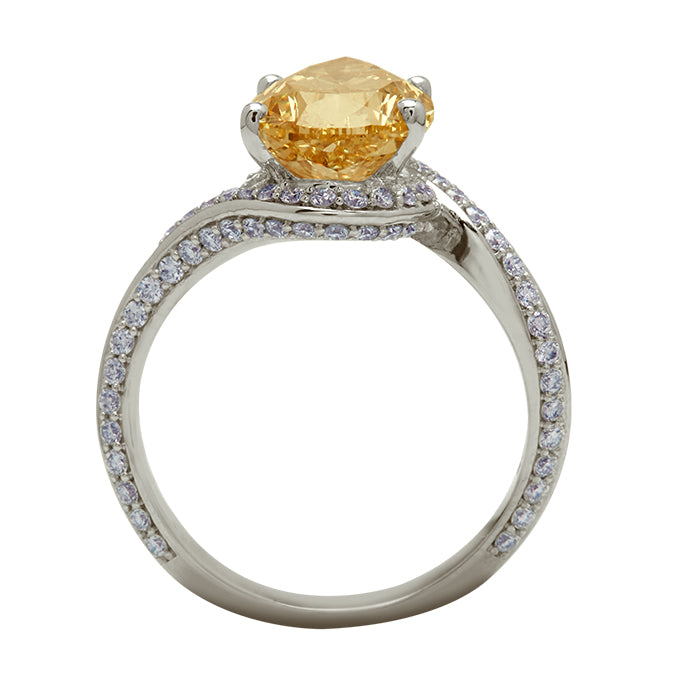 The Champagne Wave Pear Ring, a luxurious diamond ring featuring a pear-cut champagne diamond centerpiece and a unique wave-shaped band adorned with brilliant pave diamonds. Ideal for special occasions and fine diamond jewelry collections.
