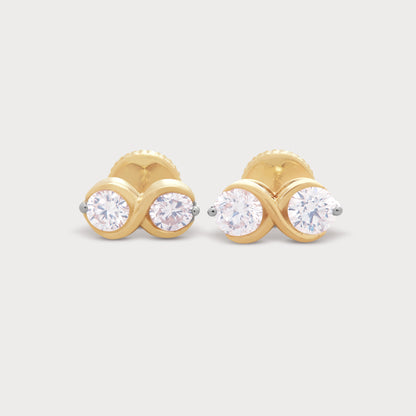 The Binolo Studs: A pair of exquisite yellow gold diamond stud earrings, each featuring two brilliant round diamonds in a modern, intertwined design.