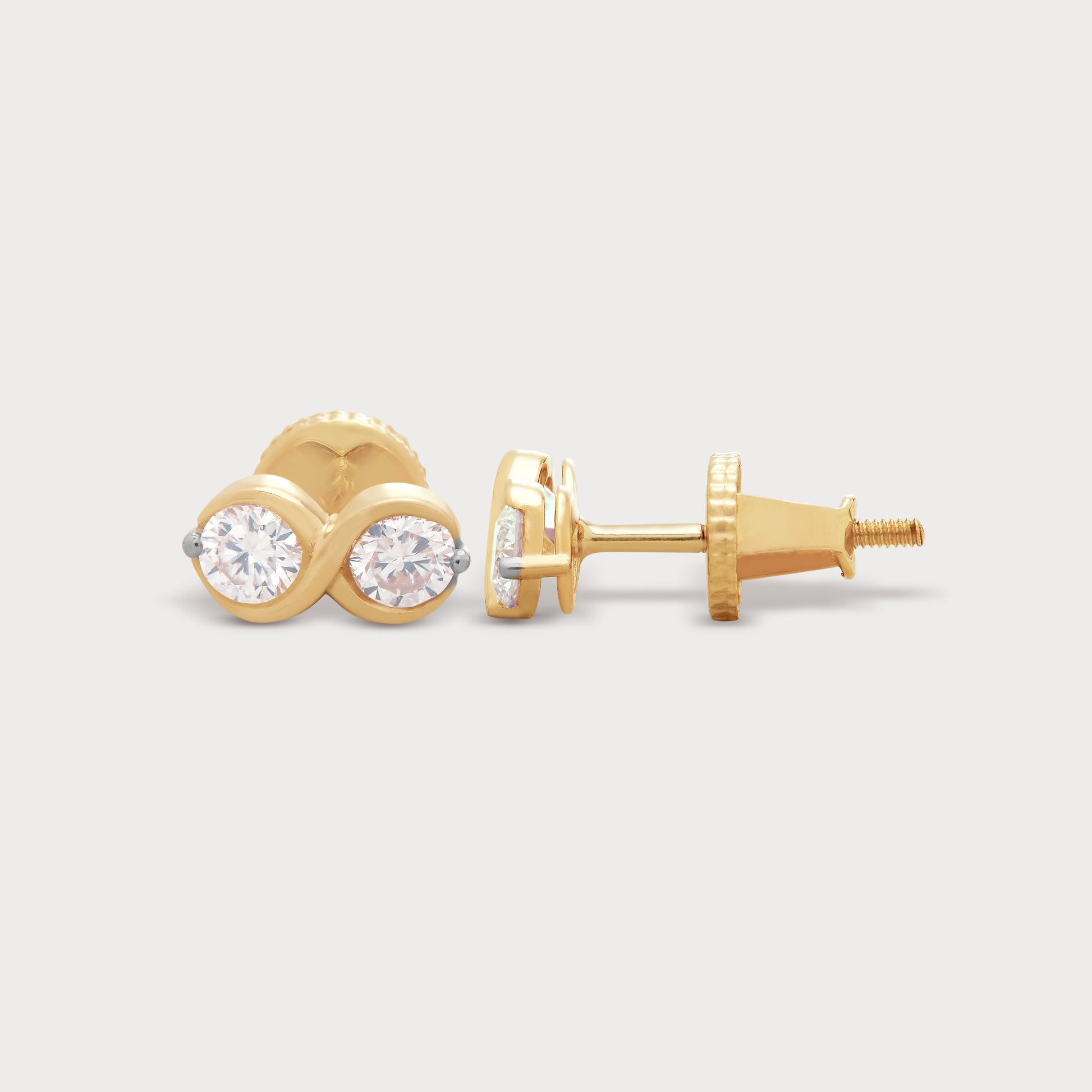 The Binolo Studs gold diamond earrings, featuring two brilliant round diamonds set in a captivating, intertwined gold design. Perfect for everyday elegance or a special gift from our diamond jewelry collection.