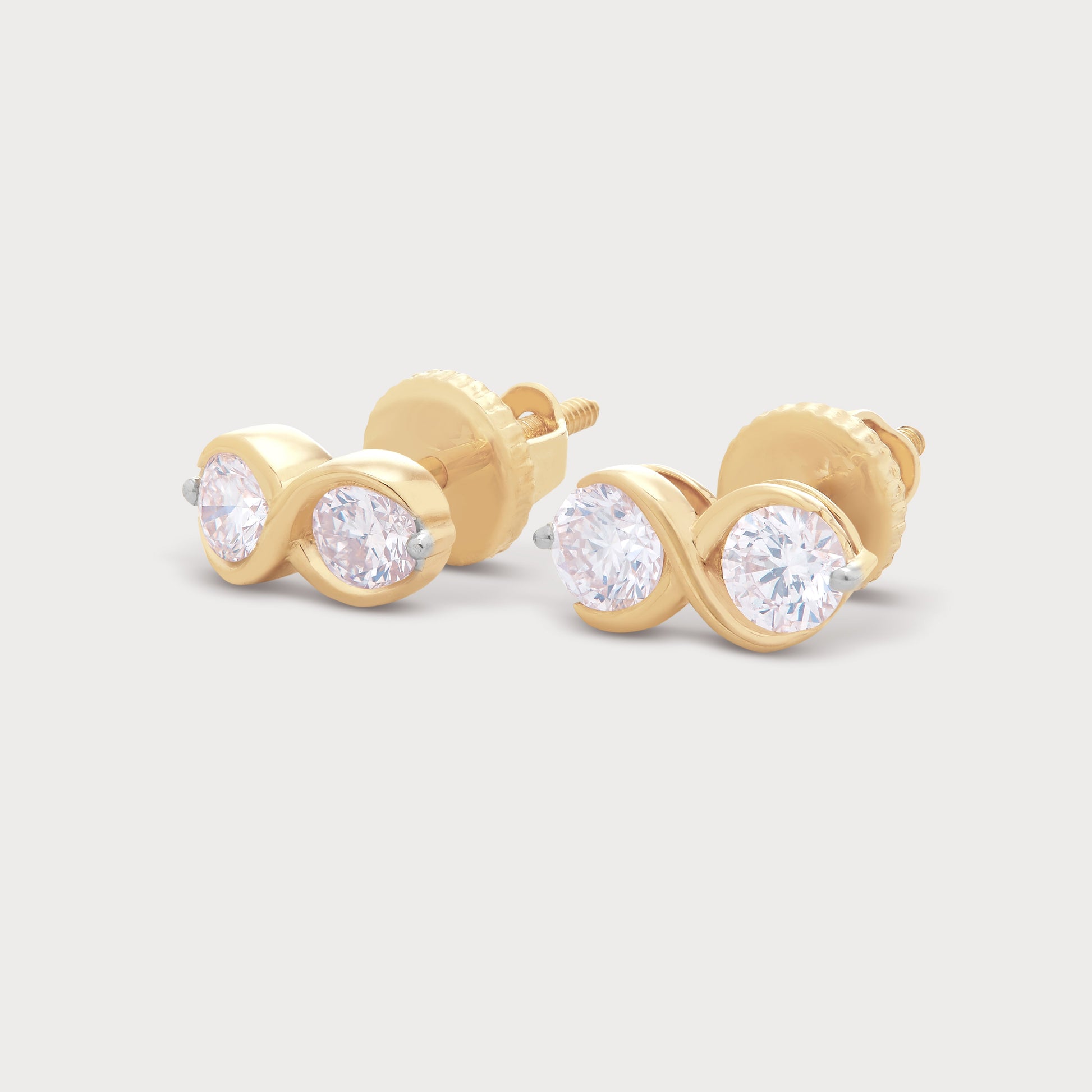 The Binolo Studs: elegant gold diamond stud earrings featuring two brilliant round diamonds in a contemporary infinity design. Ideal for diamond jewelry ecommerce.