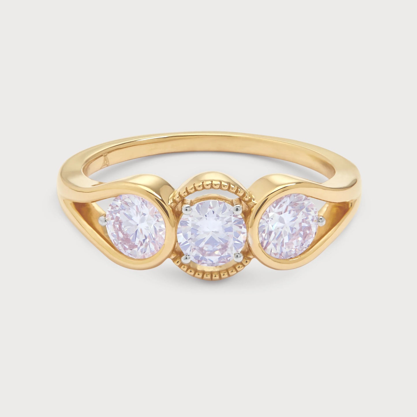 The Trilogy Ring, a stunning yellow gold three-stone diamond ring featuring three brilliant round cut diamonds, ideal for engagement, anniversary, or a statement piece of fine jewellery.