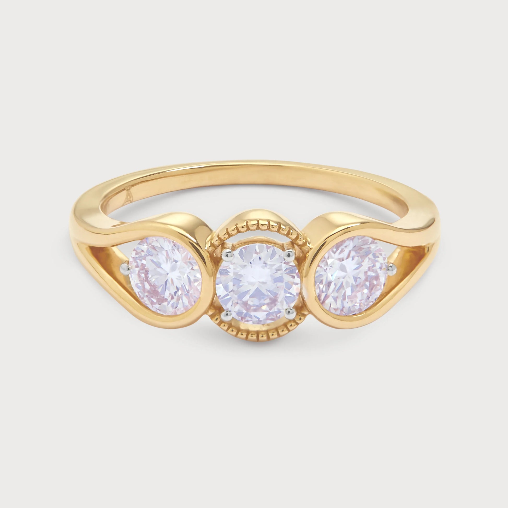 The Trilogy Ring, a stunning yellow gold three-stone diamond ring featuring three brilliant round cut diamonds, ideal for engagement, anniversary, or a statement piece of fine jewellery.