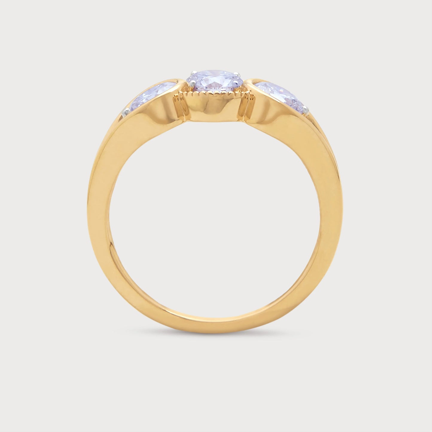The Trilogy Ring, a gold ring with three round diamonds, perfect for an e-commerce jewelry store.