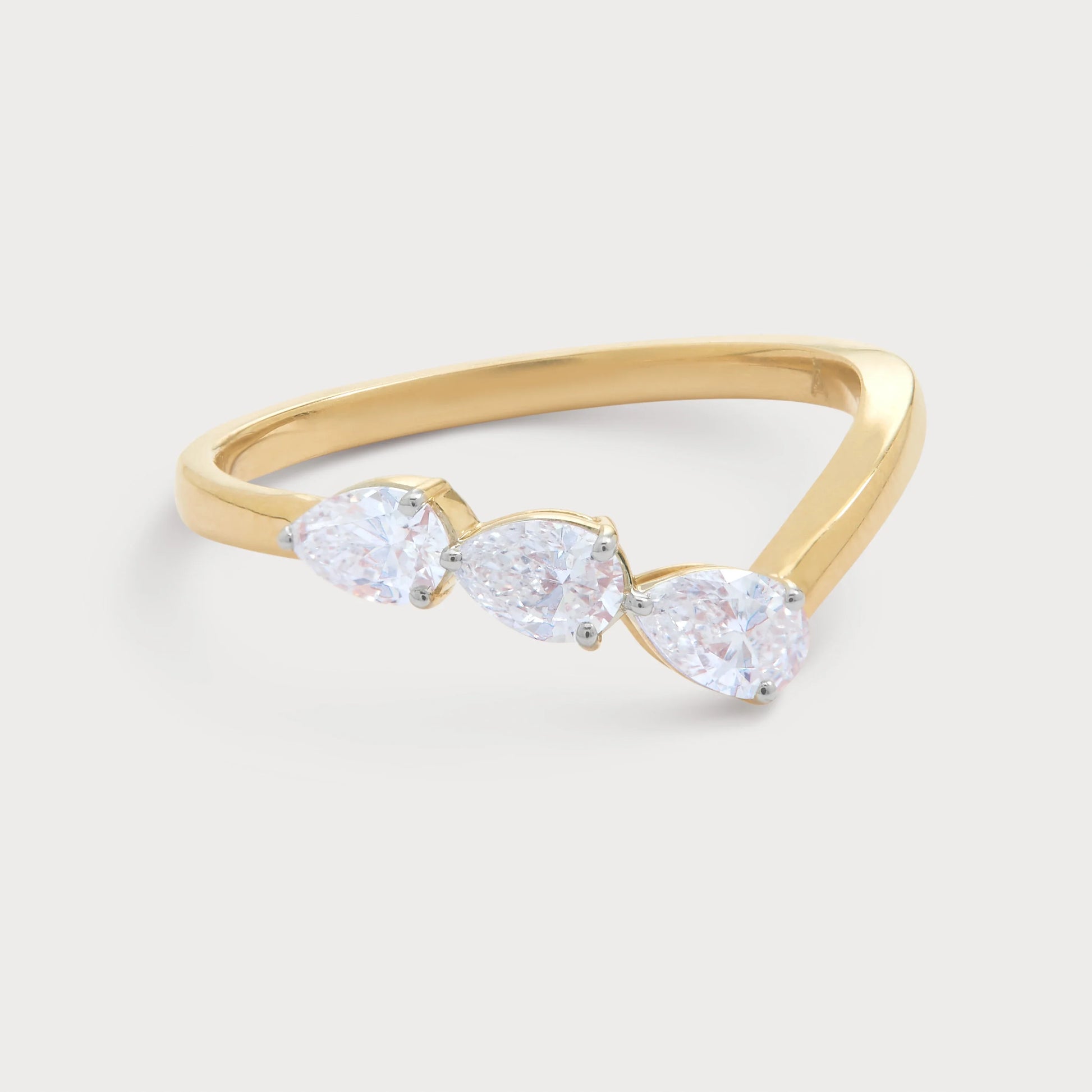The Radiant Ring - elegant gold diamond ring featuring three sparkling pear-shaped diamonds, perfect for engagement or fine jewelry.