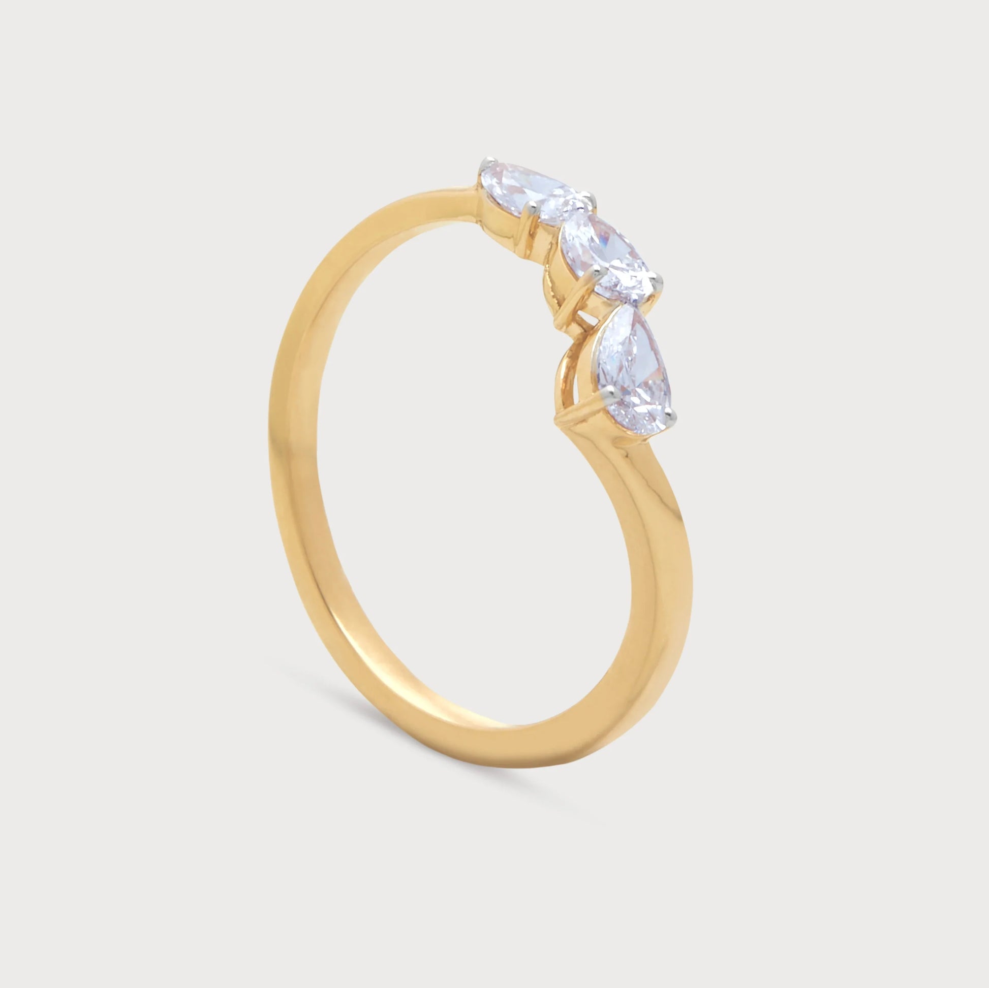 The Radiant Ring: Stunning gold ring featuring three dazzling pear-shaped diamonds, perfect for engagement, wedding, or anniversary from our fine diamond jewelry collection.