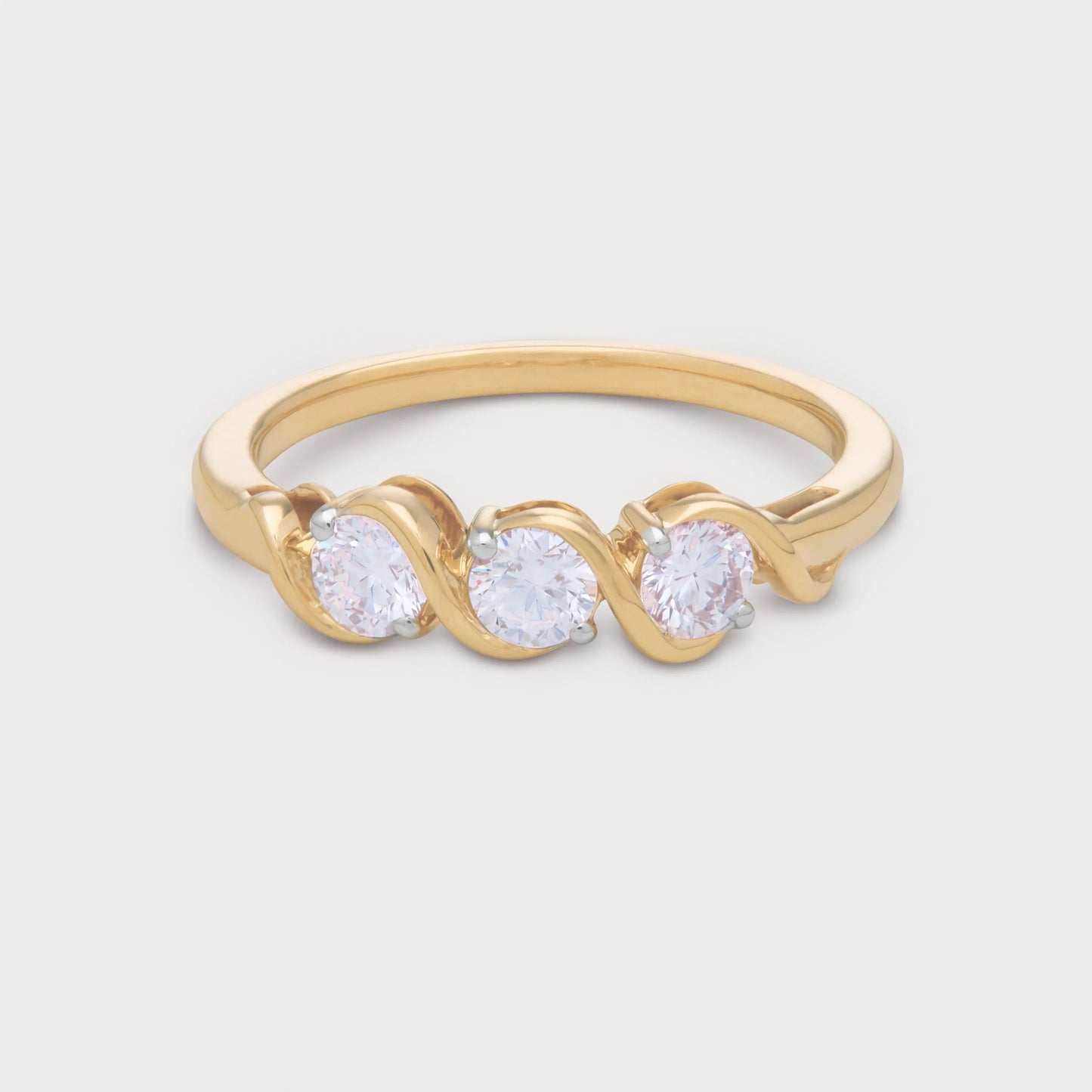 The Selene Ring: Gold three-stone diamond ring with round brilliant diamonds in a unique wavy setting. Ideal for engagement or anniversary jewelry.