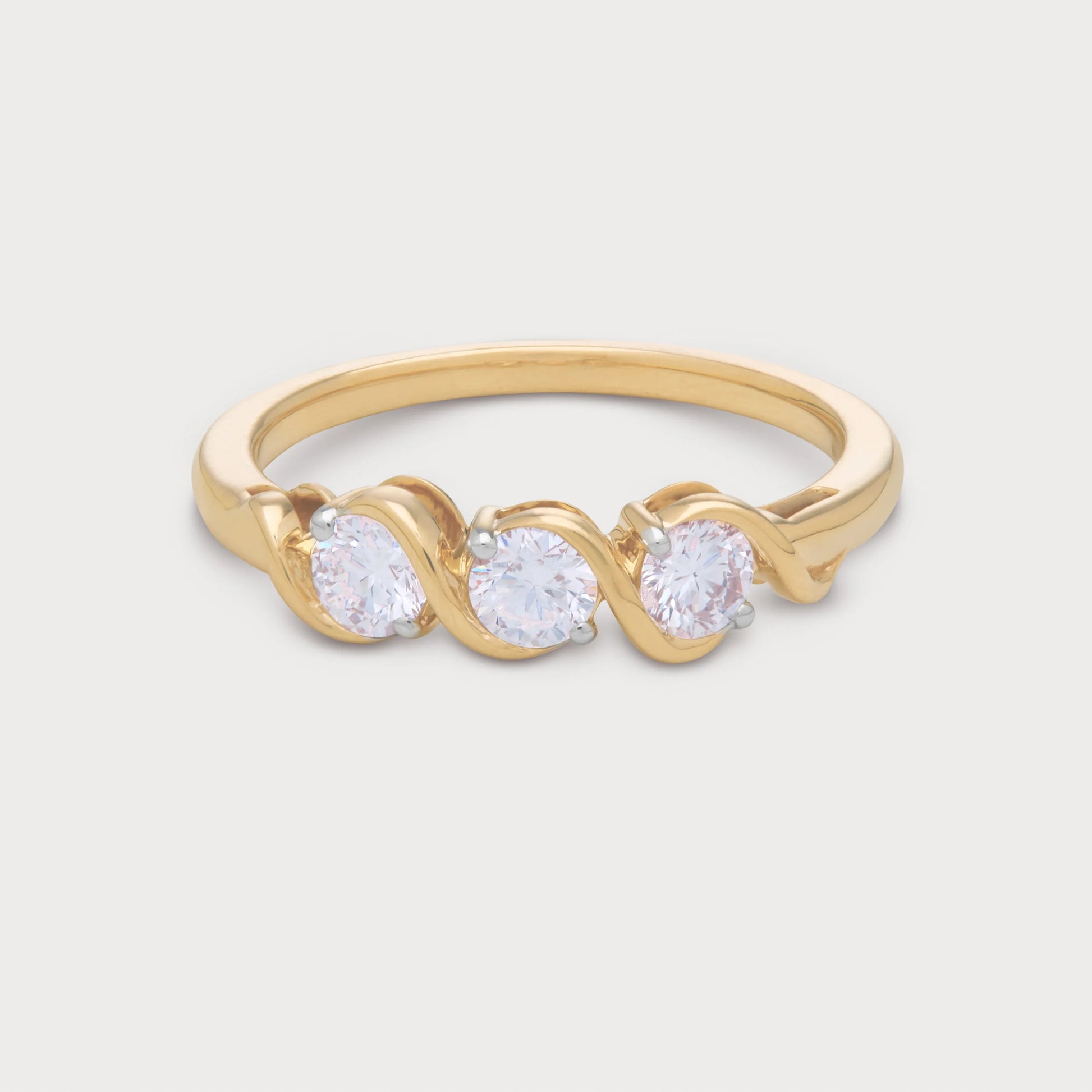The Selene Ring: Gold three-stone diamond ring with round brilliant diamonds in a unique wavy setting. Ideal for engagement or anniversary jewelry.