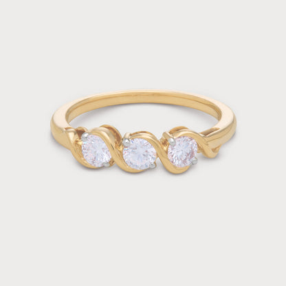 The Selene Ring: Gold three-stone diamond ring with round brilliant diamonds in a unique wavy setting. Ideal for engagement or anniversary jewelry.
