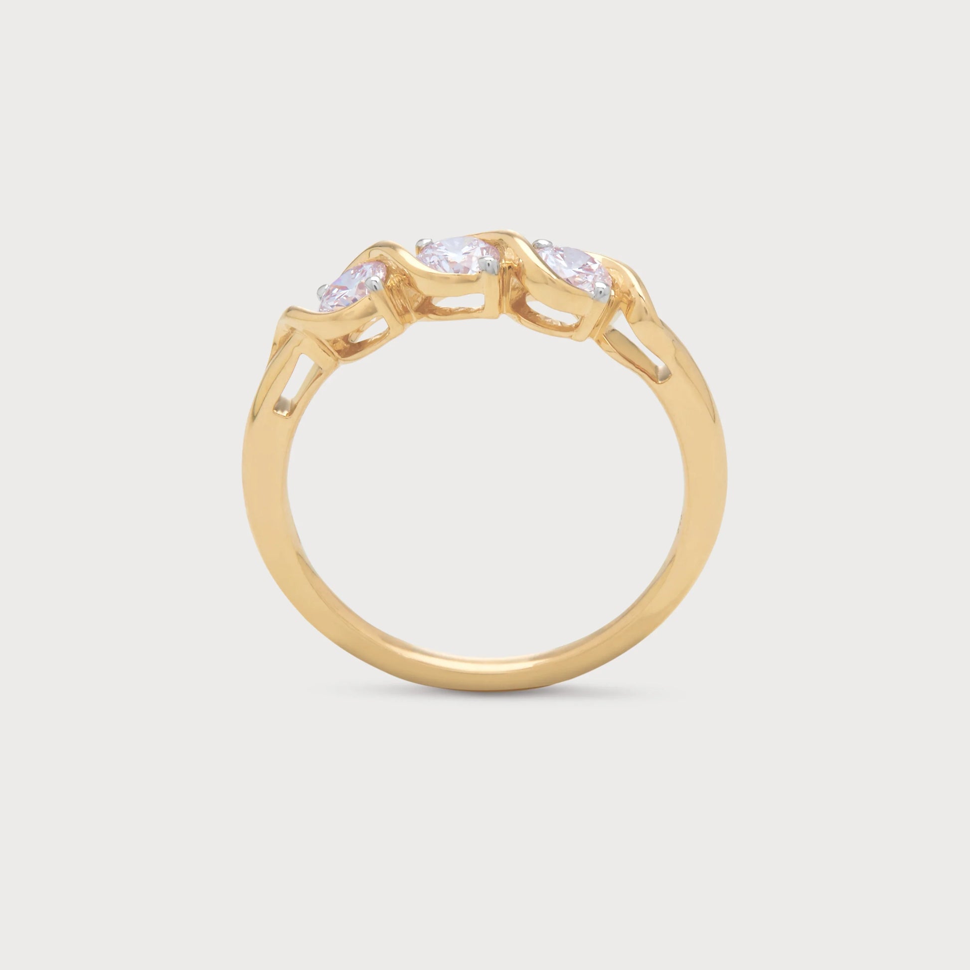 The Selene Ring, a gold three-stone diamond ring featuring an elegant intertwined band design.