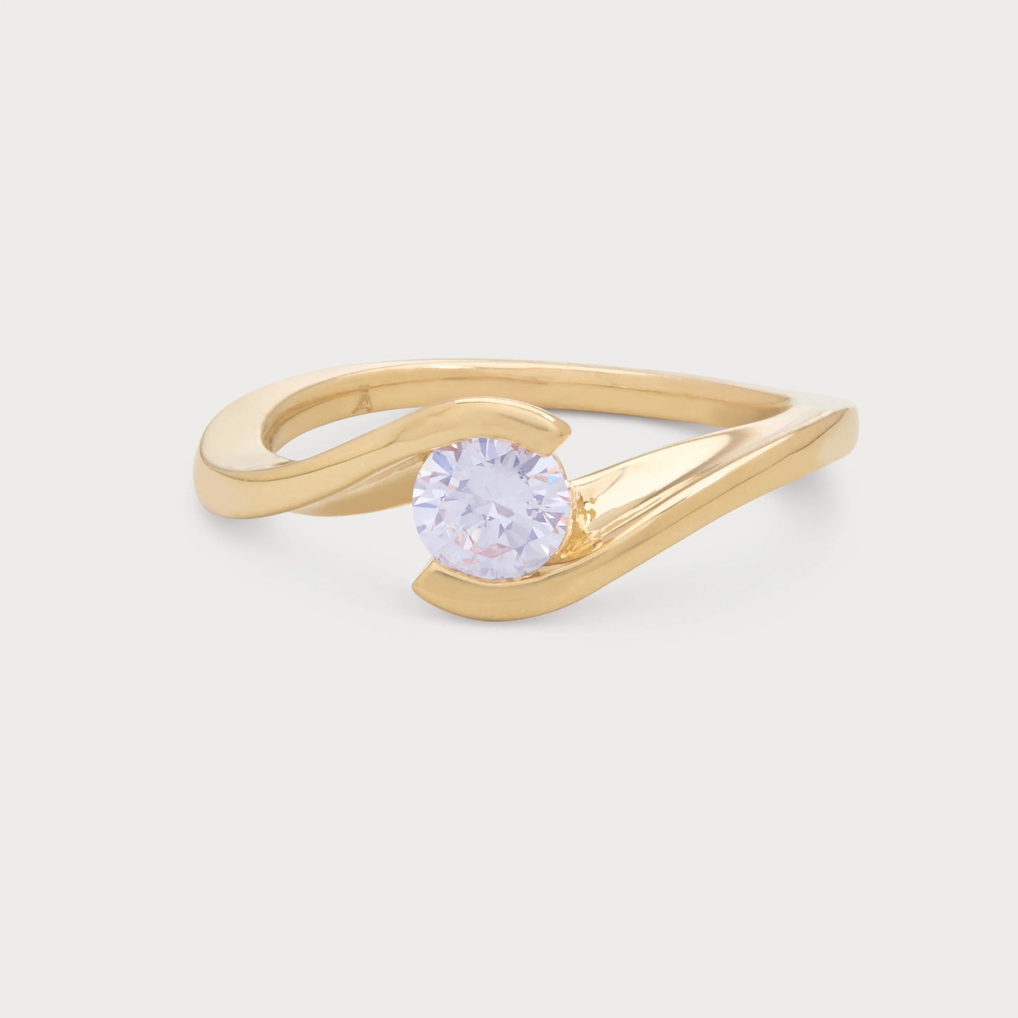 The Enfold Ring, a modern yellow gold bypass diamond ring with a brilliant round cut diamond, ideal for engagement or as a statement piece of fine jewelry.