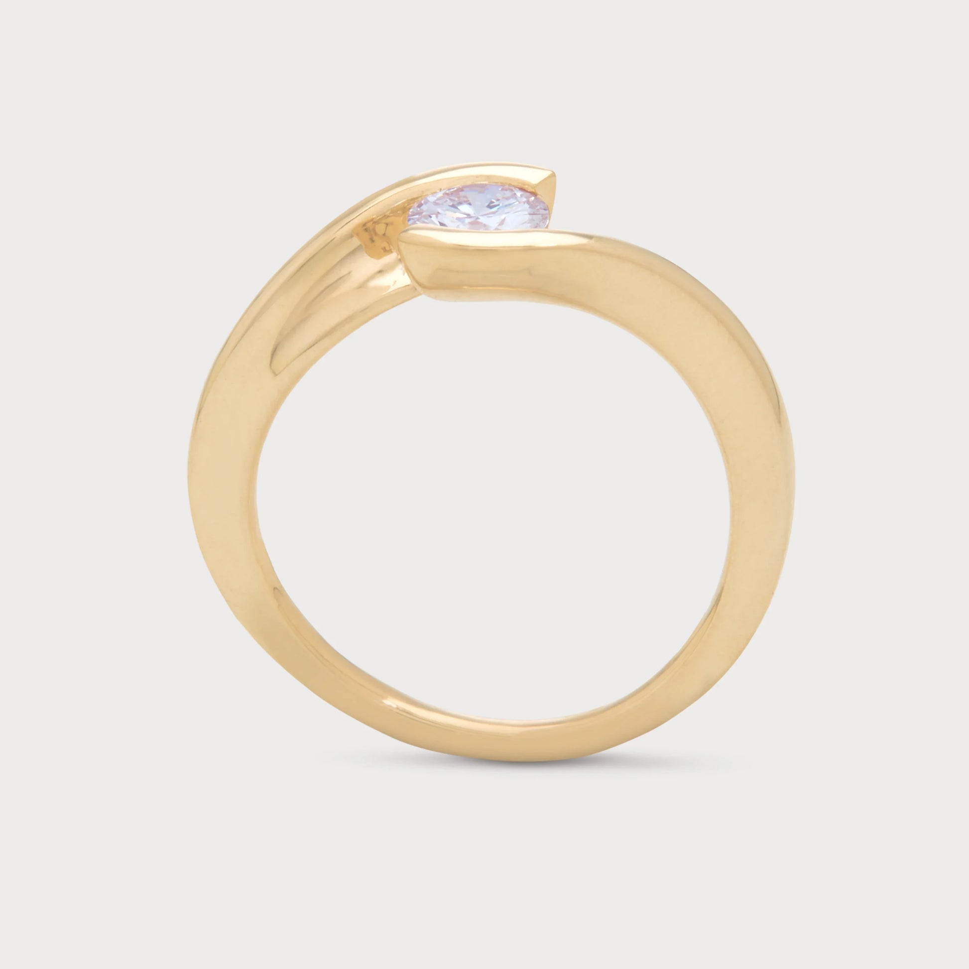 The Enfold Ring - a yellow gold diamond solitaire ring with a unique bypass setting, ideal for engagement or as fine diamond jewelry.